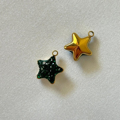 Gold and Green Gems Star Charm behind